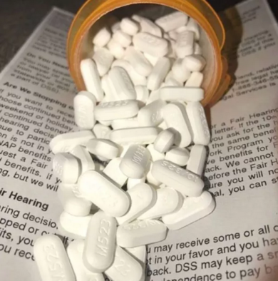 a bottle of pills spilling out of a prescription